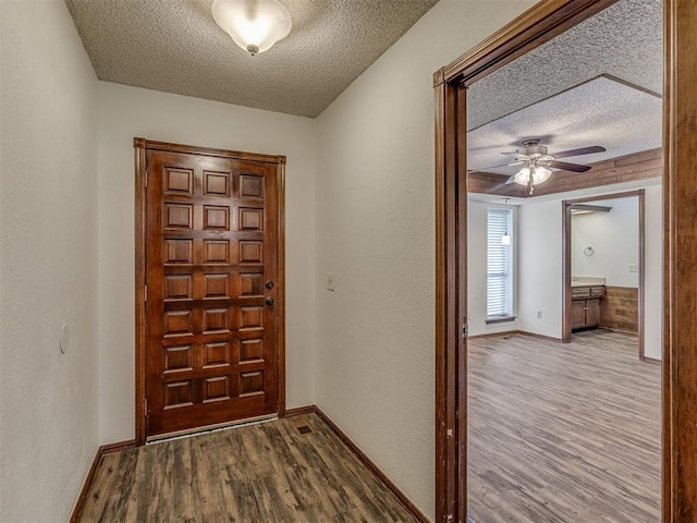 10428 Fairfax Ln, Yukon, OK 73099 - entrance foyer with a textured ceiling, wood finished floors, and a ceiling fan