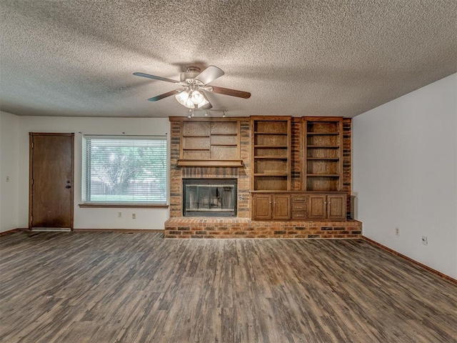 10428 Fairfax Ln, Yukon, OK 73099 - unfurnished living room with wood finished floors, a ceiling fan, a brick fireplace, and a textured ceiling