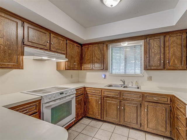 10428 Fairfax Ln, Yukon, OK 73099 - kitchen with under cabinet range hood, electric stove, light tile patterned floors, and light countertops