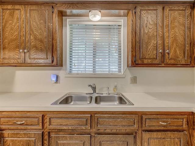 10428 Fairfax Ln, Yukon, OK 73099 - kitchen featuring light countertops and brown cabinetry