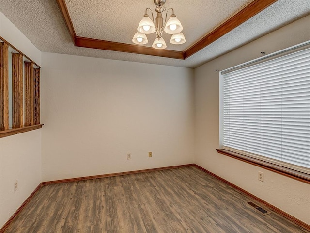 10428 Fairfax Ln, Yukon, OK 73099 - unfurnished room with a textured ceiling, a chandelier, wood finished floors, and a tray ceiling