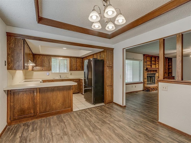 10428 Fairfax Ln, Yukon, OK 73099 - kitchen with refrigerator with ice dispenser, a textured ceiling, under cabinet range hood, open floor plan, and light countertops