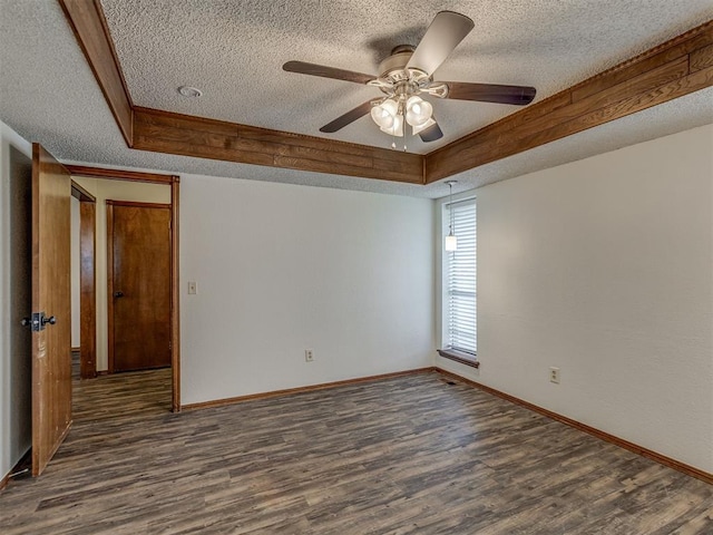 10428 Fairfax Ln, Yukon, OK 73099 - unfurnished room with a textured ceiling, a tray ceiling, dark wood-style floors, and ceiling fan