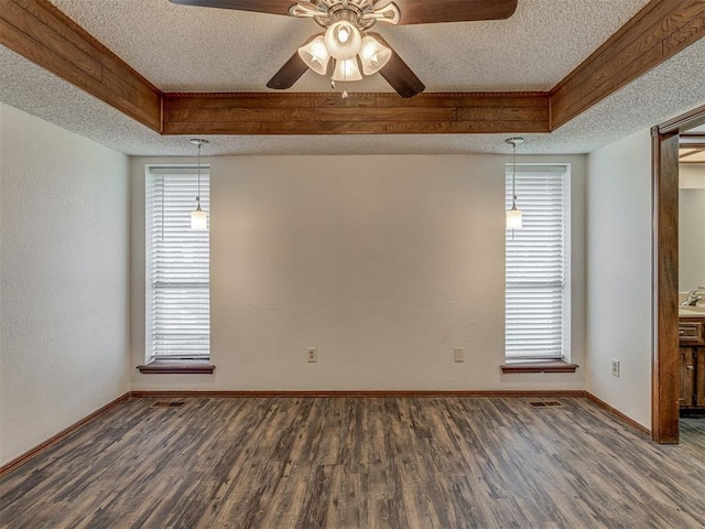 10428 Fairfax Ln, Yukon, OK 73099 - spare room featuring a textured ceiling, wood finished floors, ceiling fan, a tray ceiling, and plenty of natural light