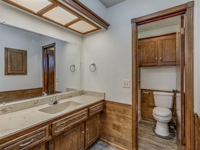 10428 Fairfax Ln, Yukon, OK 73099 - bathroom with vanity, wood finished floors, and a wainscoted wall