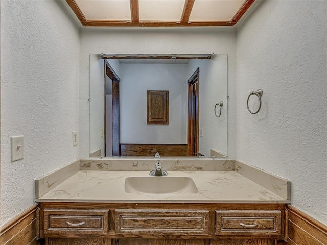 10428 Fairfax Ln, Yukon, OK 73099 - bathroom with vanity, a textured wall, and wainscoting
