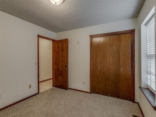 10428 Fairfax Ln, Yukon, OK 73099 - unfurnished bedroom featuring a closet, carpet, and a textured ceiling