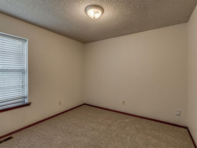 10428 Fairfax Ln, Yukon, OK 73099 - carpeted empty room with a textured ceiling and baseboards