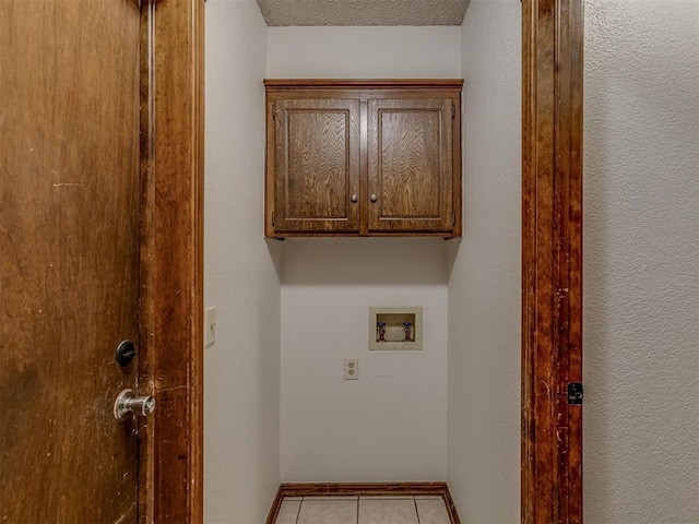10428 Fairfax Ln, Yukon, OK 73099 - washroom with washer hookup, cabinet space, and light tile patterned flooring