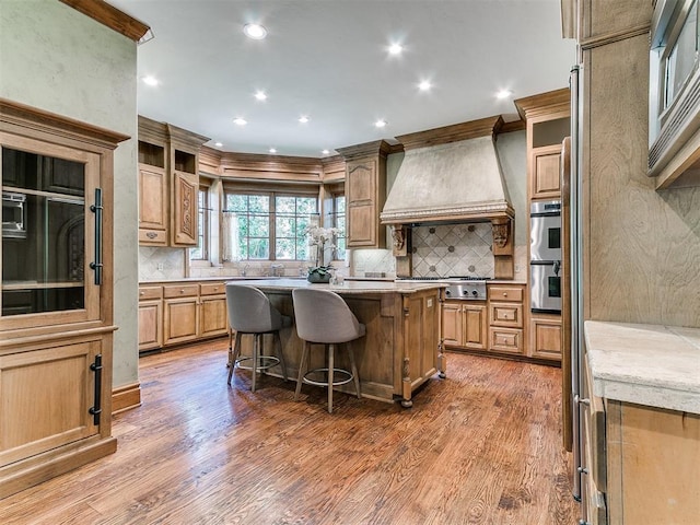 5708 Normandy Ter, Oklahoma City, OK 73142 - kitchen featuring custom range hood, recessed lighting, wood finished floors, backsplash, and ornamental molding