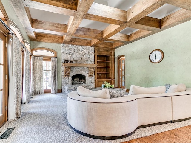 5708 Normandy Ter, Oklahoma City, OK 73142 - living room with beam ceiling, coffered ceiling, a stone fireplace, arched walkways, and built in features
