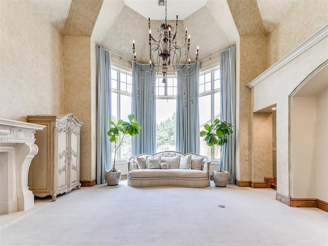 5708 Normandy Ter, Oklahoma City, OK 73142 - living area featuring a towering ceiling, carpet flooring, a chandelier, and arched walkways