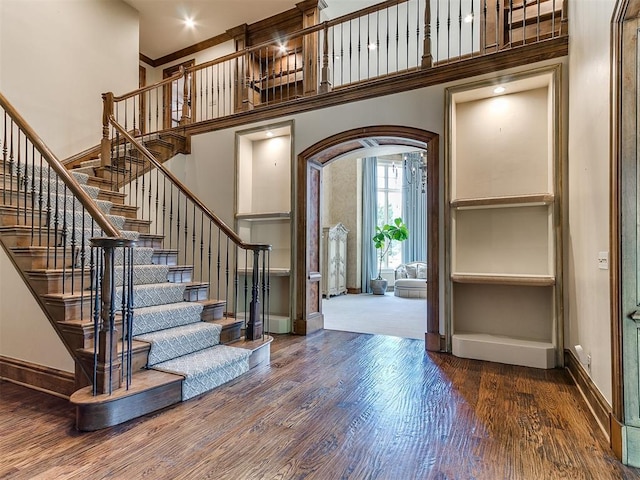 5708 Normandy Ter, Oklahoma City, OK 73142 - entrance foyer featuring wood finished floors, stairway, a towering ceiling, and crown molding