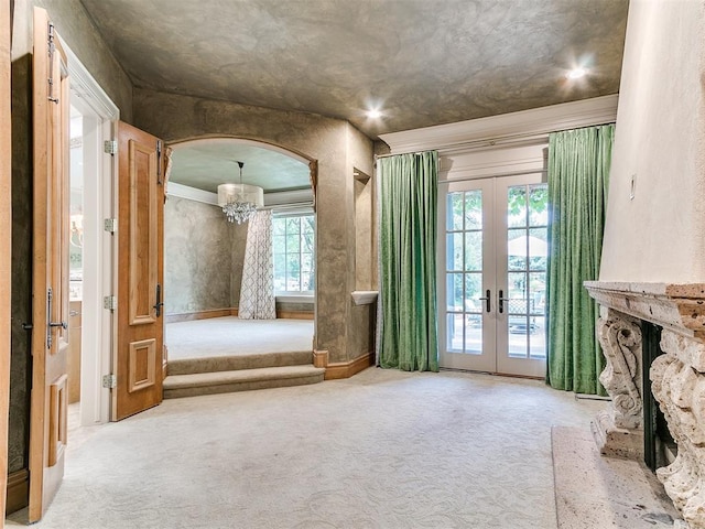 5708 Normandy Ter, Oklahoma City, OK 73142 - unfurnished living room featuring carpet floors, french doors, a chandelier, and crown molding