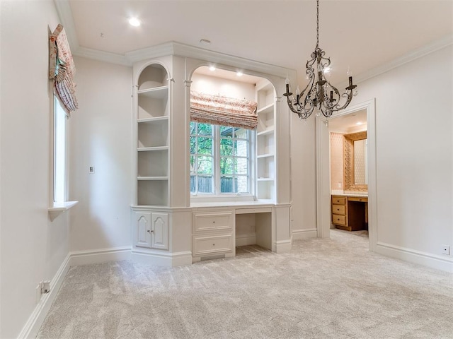 5708 Normandy Ter, Oklahoma City, OK 73142 - unfurnished bedroom featuring built in desk, carpet floors, ornamental molding, a chandelier, and ensuite bath