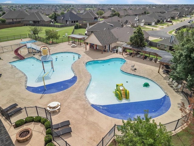 18716 Lazy Grove Dr, Edmond, OK 73012 - community pool featuring a water play area, a residential view, and a patio area