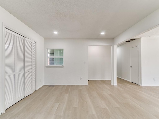 502 Walnut Ave, Yukon, OK 73099 - unfurnished bedroom featuring light wood finished floors, recessed lighting, and a textured ceiling