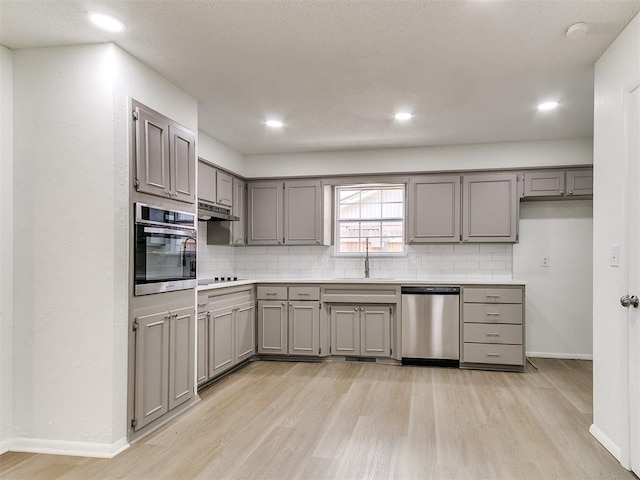 502 Walnut Ave, Yukon, OK 73099 - kitchen with stainless steel appliances, gray cabinetry, light wood finished floors, and recessed lighting