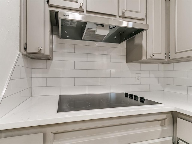 502 Walnut Ave, Yukon, OK 73099 - kitchen featuring range hood, black electric stovetop, light countertops, and decorative backsplash