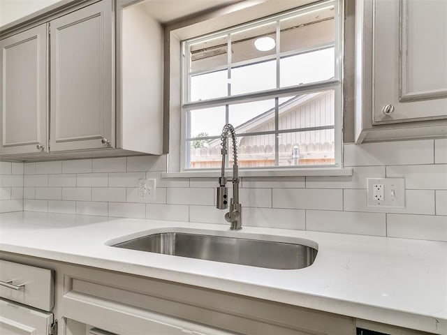 502 Walnut Ave, Yukon, OK 73099 - kitchen with gray cabinets, light countertops, and decorative backsplash
