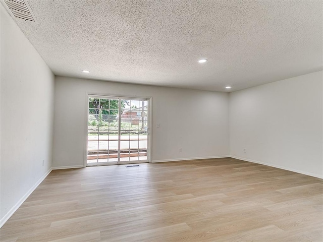 502 Walnut Ave, Yukon, OK 73099 - spare room with light wood finished floors, recessed lighting, and a textured ceiling