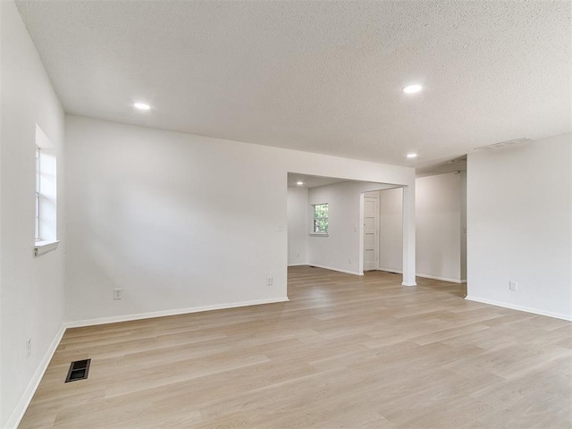 502 Walnut Ave, Yukon, OK 73099 - spare room featuring light wood finished floors, recessed lighting, and a textured ceiling