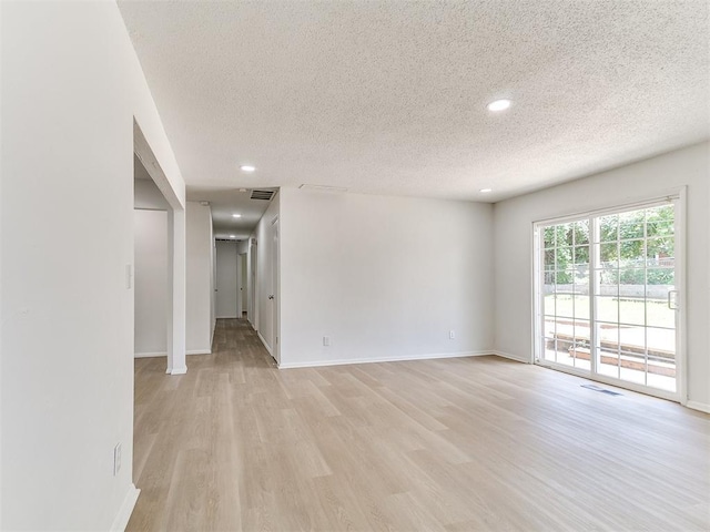 502 Walnut Ave, Yukon, OK 73099 - unfurnished room with a textured ceiling, recessed lighting, and light wood-style flooring