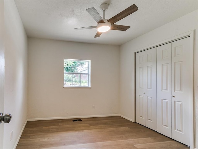 502 Walnut Ave, Yukon, OK 73099 - unfurnished bedroom featuring wood finished floors, a closet, and a ceiling fan