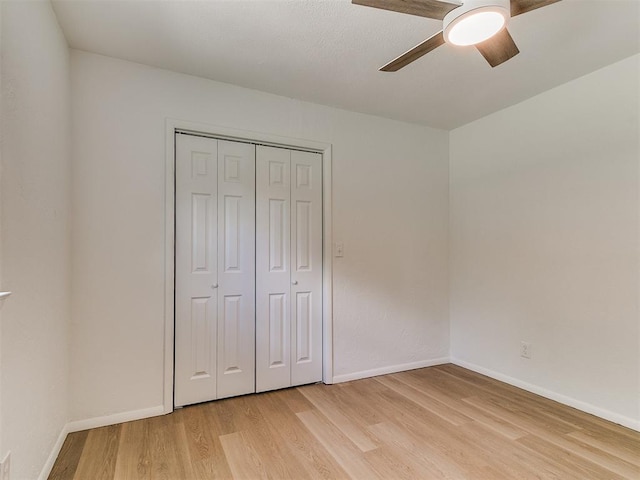 502 Walnut Ave, Yukon, OK 73099 - unfurnished bedroom with light wood finished floors, a closet, and a ceiling fan