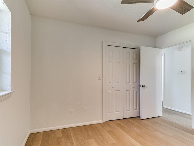 502 Walnut Ave, Yukon, OK 73099 - unfurnished bedroom featuring light wood-style floors, a closet, and a ceiling fan