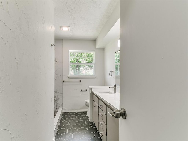 502 Walnut Ave, Yukon, OK 73099 - full bath featuring vanity, a textured ceiling, a marble finish shower, and tile patterned floors