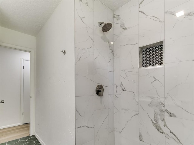 502 Walnut Ave, Yukon, OK 73099 - full bathroom with a tile shower and a textured ceiling