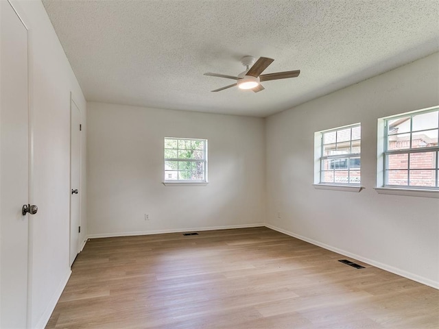 502 Walnut Ave, Yukon, OK 73099 - spare room featuring a textured ceiling, a ceiling fan, and light wood-type flooring