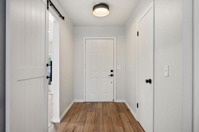 908 NW 12th St, Moore, OK 73160 - doorway with a barn door and light wood-type flooring