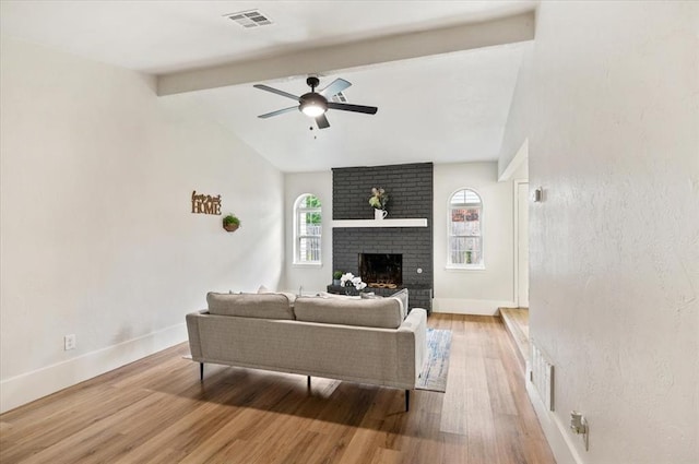 908 NW 12th St, Moore, OK 73160 - living room featuring light wood finished floors, a ceiling fan, and a fireplace