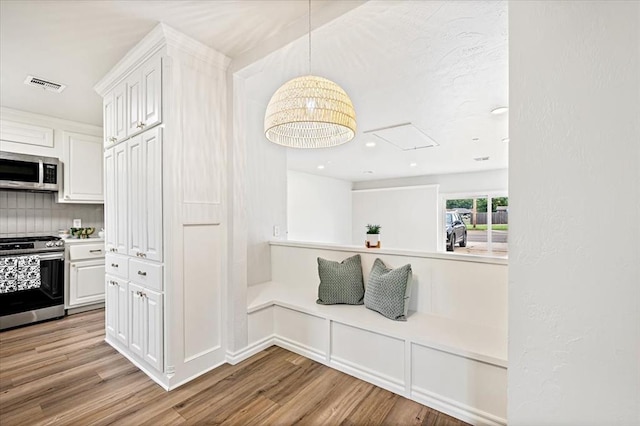 908 NW 12th St, Moore, OK 73160 - hall with attic access, wood finished floors, and recessed lighting