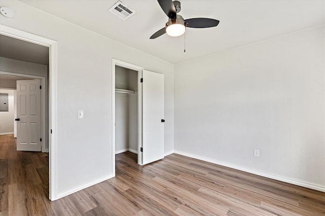 908 NW 12th St, Moore, OK 73160 - unfurnished bedroom featuring wood finished floors, a closet, and a ceiling fan