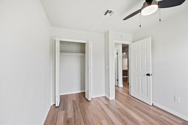 908 NW 12th St, Moore, OK 73160 - unfurnished bedroom with light wood-style flooring, a closet, and a ceiling fan