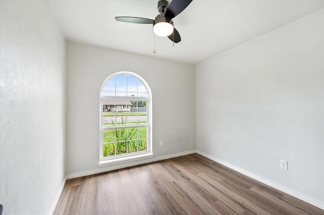 908 NW 12th St, Moore, OK 73160 - spare room featuring plenty of natural light, wood finished floors, and a ceiling fan
