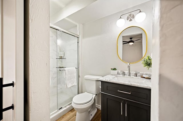 908 NW 12th St, Moore, OK 73160 - bathroom featuring vanity, a shower stall, wood finished floors, and ceiling fan