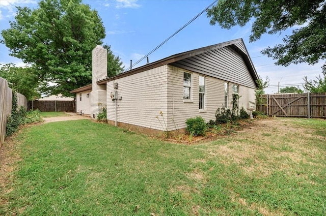 908 NW 12th St, Moore, OK 73160 - view of side of property featuring a fenced backyard and a chimney