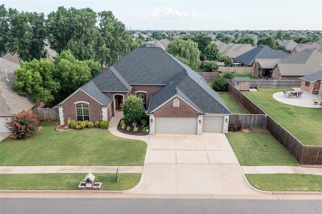 1704 NW 171st St, Edmond, OK 73012 - view of front of property featuring a garage, driveway, a shingled roof, and brick siding