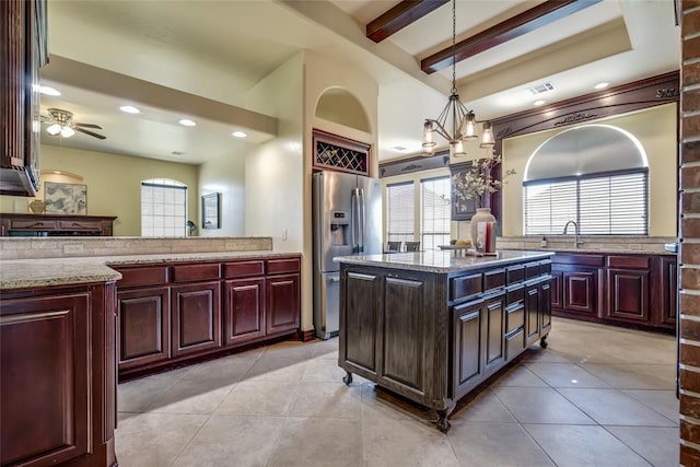 1704 NW 171st St, Edmond, OK 73012 - kitchen featuring stainless steel refrigerator with ice dispenser, a ceiling fan, beamed ceiling, decorative light fixtures, and light stone countertops