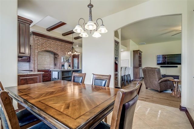 1704 NW 171st St, Edmond, OK 73012 - dining area featuring a chandelier, arched walkways, and light tile patterned floors