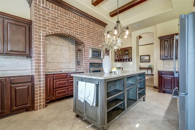 1704 NW 171st St, Edmond, OK 73012 - kitchen with appliances with stainless steel finishes, open shelves, tasteful backsplash, pendant lighting, and light stone countertops