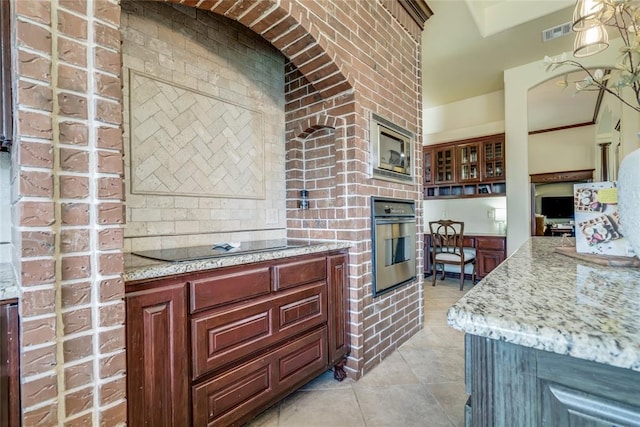 1704 NW 171st St, Edmond, OK 73012 - kitchen with appliances with stainless steel finishes, light tile patterned floors, and light stone countertops