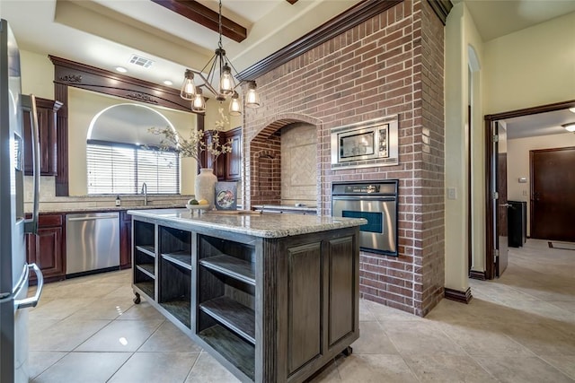 1704 NW 171st St, Edmond, OK 73012 - kitchen with stainless steel appliances, open shelves, a chandelier, decorative light fixtures, and light stone countertops