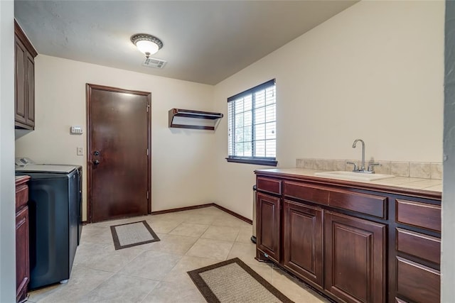 1704 NW 171st St, Edmond, OK 73012 - washroom featuring cabinet space, washing machine and clothes dryer, and light tile patterned flooring