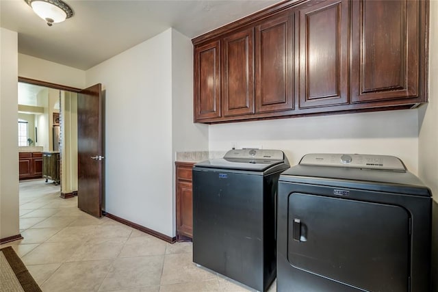 1704 NW 171st St, Edmond, OK 73012 - laundry room with cabinet space, washing machine and clothes dryer, and light tile patterned flooring