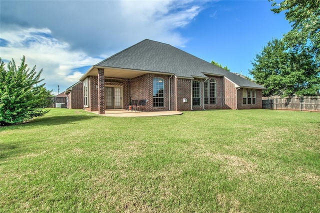 1704 NW 171st St, Edmond, OK 73012 - rear view of property featuring brick siding, a patio, and a shingled roof
